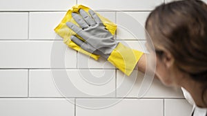 Houseworker wipes the surface with a napkin