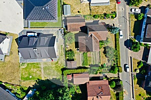 Housing estate with single-family houses, garden and lawn and neighbour, taken from a vertical perspective