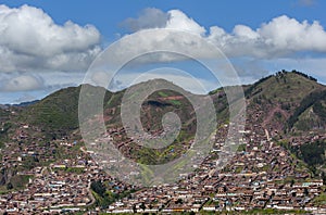 Housing subdivisions move up the steep mountains surrounding Cusco in Peru. photo