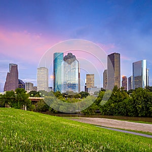 Houston Texas skyline at sunset twilight from park lawn