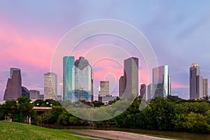 Houston Texas skyline at sunset twilight from park lawn