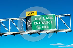 HOV lane entrance road sign. Blue sky