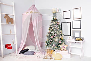 Hovel prepared for children. Beautiful New Year decor of the children room Christmas house. photo