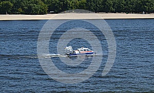 The hovercraft moves along the river