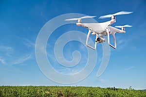 Hovering drone taking pictures of green hills