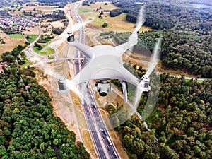 Hovering drone taking pictures of highway in forest, Netherlands