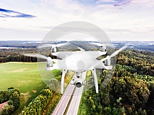 Hovering drone taking pictures of highway in green forest. Netherlands