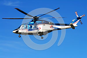 Hovering helicopter on blue sky. photo