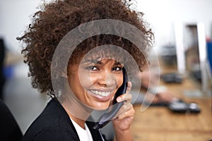 And how can I be of service. Portrait of an attractive young female call center operator.