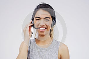 And how can I be of service. Studio portrait of an attractive young female customer service representative wearing a