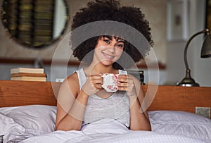 How could he know he had found treasure. Portrait of a beautiful young woman having a cup of coffee in bed at home.