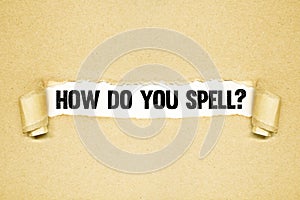 How do you spell?   Torn paper revealing words