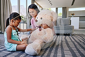 How many beats per minute. a little girl playing doctor with her mother using her teddy bear.