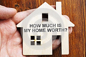 How much is my home worth? Sign on the model of house photo