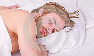 How much sleep you actually need. Man handsome guy lay in bed. Get adequate and consistent amount of sleep every night