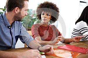 How should we go about this. two design professionals having a discussion while seated at a table.