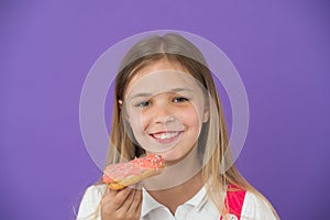 How tame childs sweet tooth. Kid rewarded for good behavior with sugary treats. Girl cute smiling face holds sweet donut