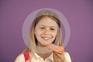 How tame childs sweet tooth. Kid rewarded for good behavior with sugary treats. Girl cute smiling face holds sweet donut