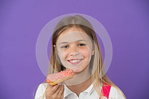 How tame childs sweet tooth. Kid rewarded for good behavior with sugary treats. Girl cute smiling face holds sweet donut photo