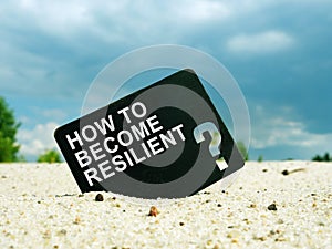 How to Become Resilient words on black plate. Resilience concept. photo