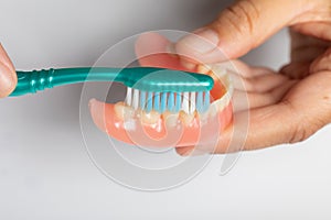 How to cleaning dental prothesis with toothbrush photo