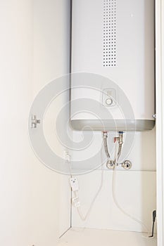 How to hide water boiler: white water heater installed in a cabinet, cupboard in bathroom, kitchen