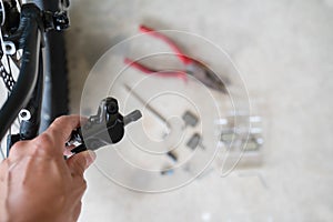 How to maintenance a mtb hydraulic disc brake caliper : Repairman holding a Hydraulic rear disc brake caliper on a mountain bike. photo