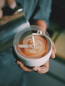 How to make coffee latte art by barista in vintage color tone photo