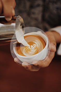 How to make coffee latte art by barista in vintage color tone photo