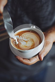 How to make coffee latte art by barista in vintage color tone photo