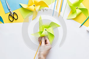 How to make paper green windmill toy with children at home. Step by step instructions. Step 12. Enjoy ready toy