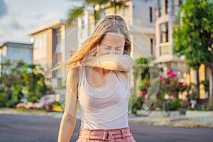 How to sneeze correctly. Woman sneezes on the elbow. Concept of the spread of the virus