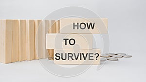 How to Survive - words on wooden blocks. Surviving concept. Desease and epidemy survival healthcare coronavirus prevention concept