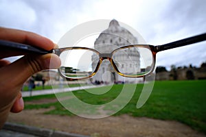 A tourist sees the pissa monuments through her glases photo