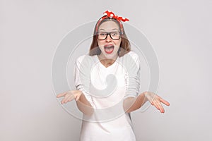 how you did this? its unbelievable. portrait of beautiful emotional young woman in white t-shirt with freckles, black glasses, re