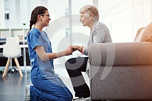 How are you feeling today. a young female nurse talking to her senior patient in the old age home.