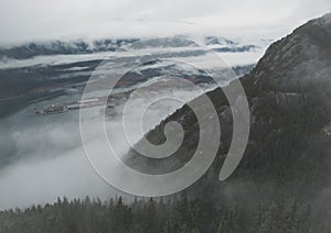 The Howe Sound appears between layers of clouds in British Columbia