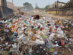 Pollution from city garbage, a poor man hunting food from garbage at Howrah baghar dumping ground.