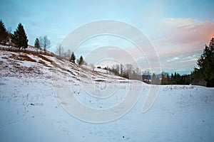 Howse in the snow and hills with trees blue