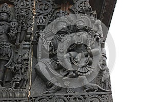 Hoysaleshwara Temple wall carving of lord shiva and parvati below is her mongoose