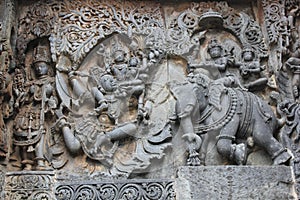 Hoysaleswara Temple outside wall carved with sculpture of Lord Indira chasing Lord krishna for stealing parijatha flower