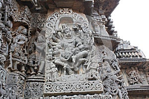 Hoysaleswara temple wall carved with incarnation of lord vishnu as Narasimha killing the demon king Hiranyakashipu