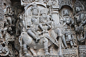 Hoysaleswara Temple wall carved with sculpture of lord shiva and parvati