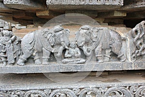 Hoysaleswara Temple Wall carved with sculpture of Prahlada attacked by elephants