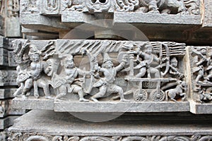 Hoysaleswara Temple wall carved with sculpture of warriors and ancient battle scene