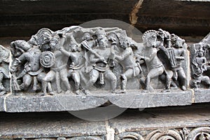 Hoysaleswara Temple wall carved with sculpture of warriors and ancient battle scene