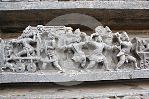 Hoysaleswara Temple wall carved with sculpture of warriors and ancient battle scene