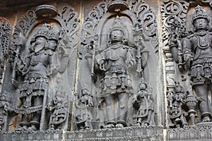 Hoysaleswara Temple wall carving of Brahma Originator Vishnu Guardian and Shiva Destroyer