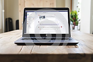HP laptop on table with Microsoft Teams on screen