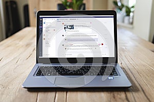 HP laptop on table with Microsoft Teams on screen